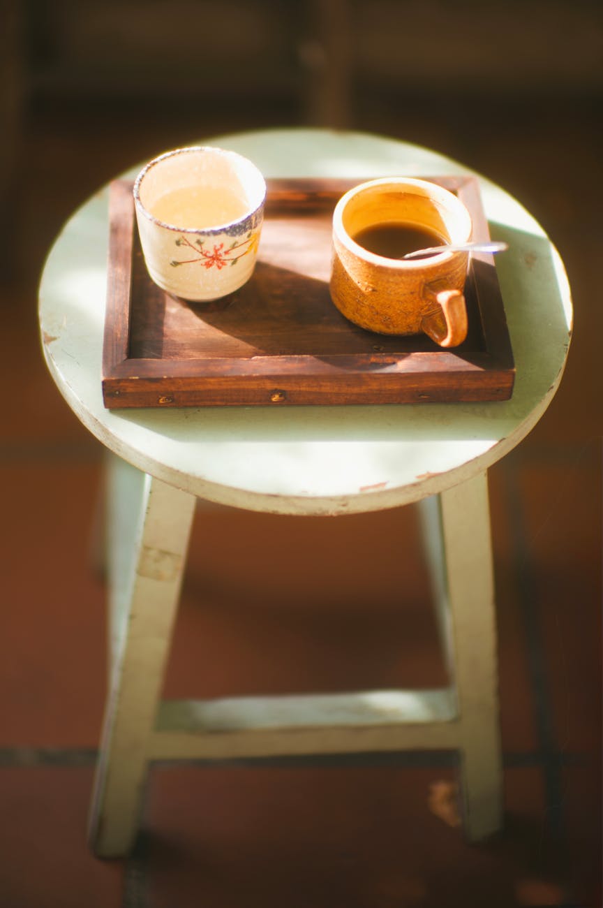 Cozy evening decaf coffee on a wooden tray with warm ambient light