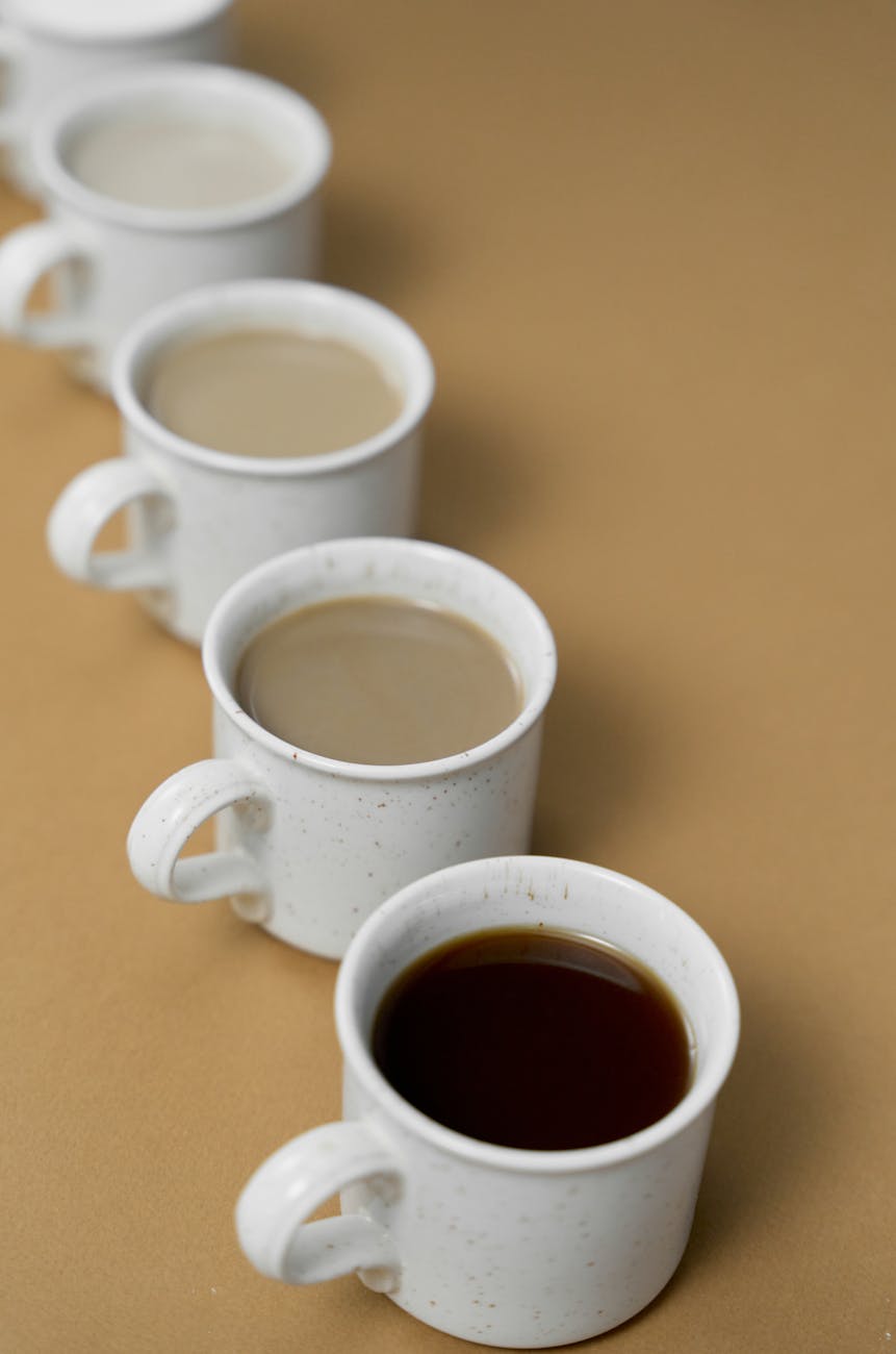 Row of coffee cups showing coffee roast levels from light to dark